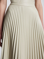 Detail image of model wearing Faux Leather Pleated Skirt in CHALK