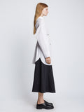Side full length image of model wearing Soft Poplin Button Down Shirt Dress in OFF WHITE