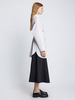Side full length image of model wearing Soft Poplin Button Down Shirt Dress in OFF WHITE