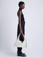 Image of model wearing Large Drawstring Shoulder Bag in OPTIC WHITE