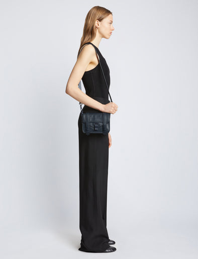 Image of model carrying Tonal PS1 Mini Crossbody Bag in DARK NAVY