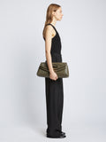 Image of model carrying Bar Bag in OLIVE with handles down