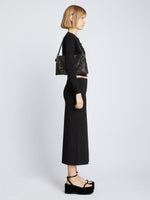 Image of model carrying Carved Python Braid Bag in BLACK on shoulder