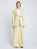 Front full length image of model wearing Viscose Suiting Jacket in PARCHMENT with jacket open and white t-shirt underneath