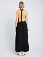 Back full length image of model wearing Matte Crepe Twist Back V-Neck Dress in BLACK