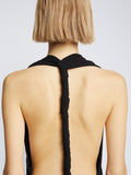 Detail image of model wearing Matte Crepe Twist Back V-Neck Dress in BLACK