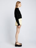 Side full length image of model wearing Textured Cotton Sweater in BLACK