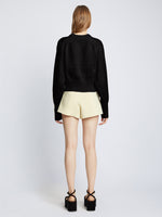 Back full length image of model wearing Textured Cotton Sweater in BLACK