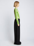 Side full length image of model wearing Painted Stripe T-Shirt in GREEN MULTI