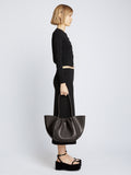 Image of model carrying Carved Python Large Ruched Tote in BLACK in hand