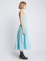 Side full length image of model wearing Eco Poplin Pintuck Dress in BABY BLUE