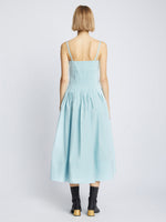 Back full length image of model wearing Eco Poplin Pintuck Dress in BABY BLUE