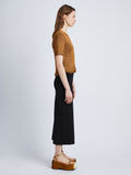 Side full length image of model wearing Ribbon Crochet Fringe Top in SADDLE