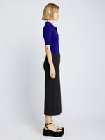 Side full length image of model wearing Silk Viscose Polo Bodysuit in COBALT