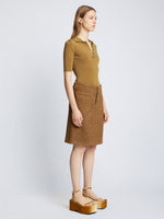 Side full length image of model wearing Silk Viscose Polo Bodysuit in OCHRE