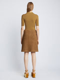 Back full length image of model wearing Silk Viscose Polo Bodysuit in OCHRE