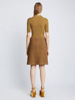 Back full length image of model wearing Silk Viscose Polo Bodysuit in OCHRE