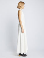 Side full length image of model wearing Matte Crepe Twist Back V-Neck Dress in WHITE