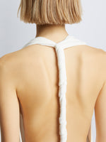 Detail image of model wearing Matte Crepe Twist Back V-Neck Dress in WHITE