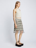 Side full length image of model wearing Graphic Beaded Fringe Embroidered Top in WHITE MULTI