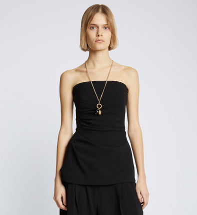Cropped front image of model in Matte Viscose Crepe Strapless Top in Black