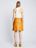 Back full length image of model wearing Glossy Leather Skirt in CARAMEL