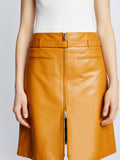 Detail image of model wearing Glossy Leather Skirt in CARAMEL