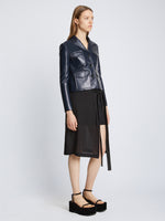 Side full length image of model wearing Glossy Leather Jacket in NAVY