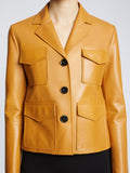 Detail image of model wearing Glossy Leather Jacket in CARAMEL