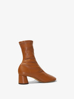 Back 3/4 image of GLOVE STRETCH ANKLE BOOTS in Medium Orange