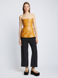 Front full length image of model wearing Glossy Leather Strapless Top in CARAMEL