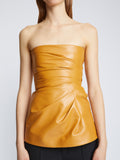 Detail image of model wearing Glossy Leather Strapless Top in CARAMEL