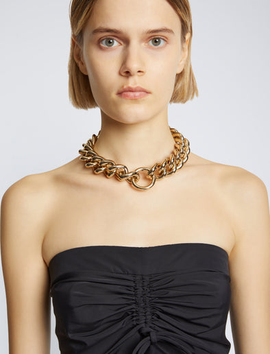 Image of chain necklace in gold on model