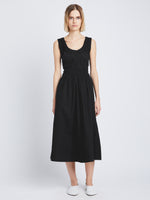 Front full length image of model wearing Poplin Gathered Dress in BLACK styled with white pants