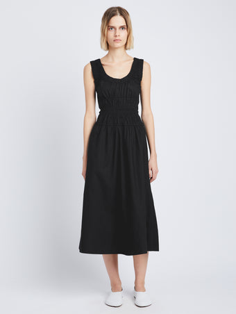 Front full length image of model wearing Poplin Gathered Dress in BLACK styled with white pants