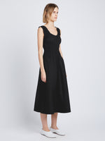 Side full length image of model wearing Poplin Gathered Dress in BLACK