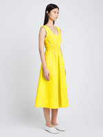 Side image of model wearing Poplin Gathered Midi Dress in sun