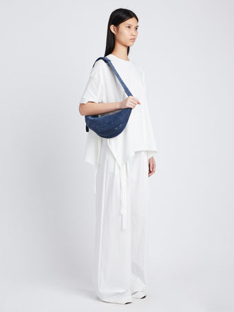 Image of model wearing Stanton Suede Sling Bag in SLATE BLUE