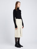 Side full length image of model wearing Denim Midi Skirt in PARCHMENT