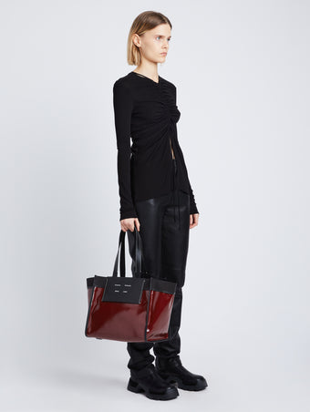 Image of model wearing Large Morris Coated Canvas Tote in BORDEAUX