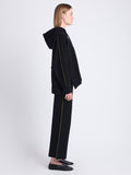 Side image of model wearing Grace Pant In Cotton Cashmere in black/leaf