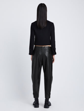 Back full length image of model wearing Kay Leather Pant in BLACK buckled