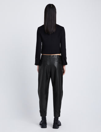 Back full length image of model wearing Kay Leather Pant in BLACK buckled