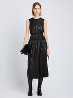 Front full length image of model wearing Faux Leather Drawstring Dress in BLACK