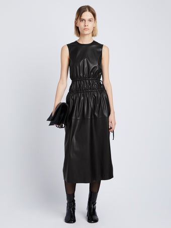 Front full length image of model wearing Faux Leather Drawstring Dress in BLACK