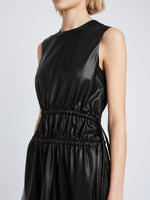 Detail image of model wearing Faux Leather Drawstring Dress in BLACK