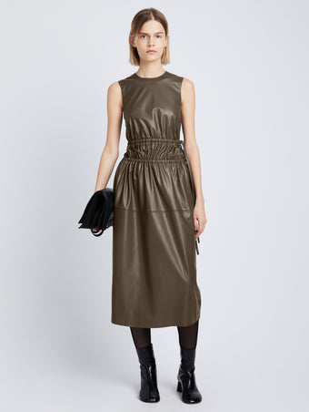 Front full length image of model wearing Faux Leather Drawstring Dress in WOOD