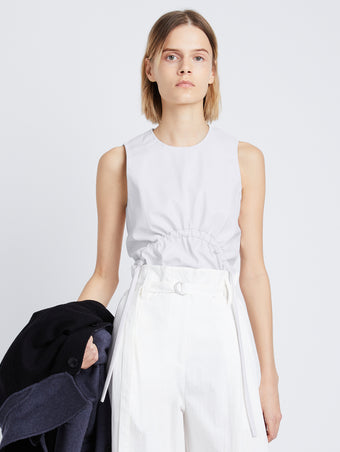 Front cropped image of model wearing Faux Leather Drawstring Top in OFF WHITE