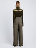 Back full length image of model wearing Stretch Velvet Turtleneck Top in MILITARY buttoned