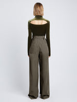 Back full length image of model wearing Stretch Velvet Turtleneck Top in MILITARY unbuttoned